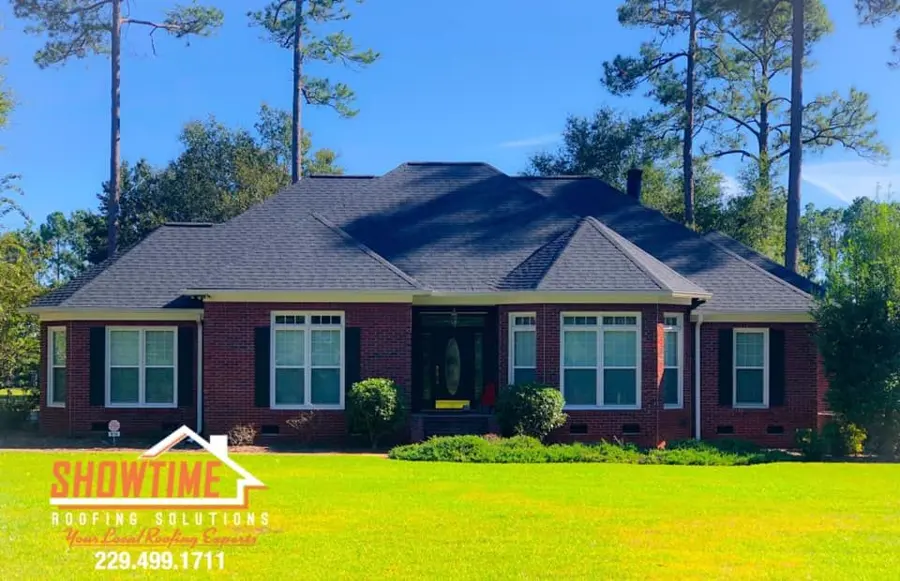 Brick ranch house with a new dark shingle roof